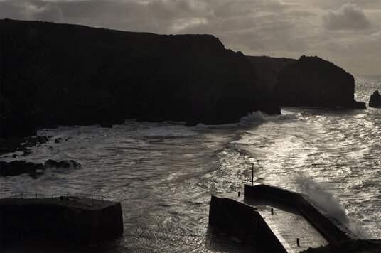 Wave breaking over the harbour wall