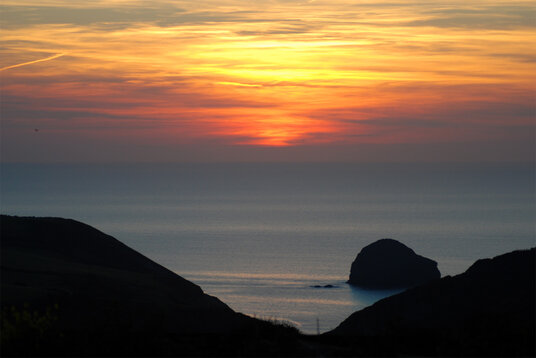 Sunset over Trebarwith Strand from Trewarmett
