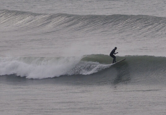 Keen surfer at Polzeath on a cold January day
