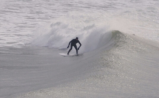 Keen surfer at Polzeath on a cold January day